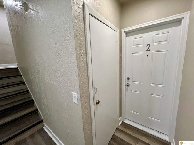 doorway with dark hardwood / wood-style flooring