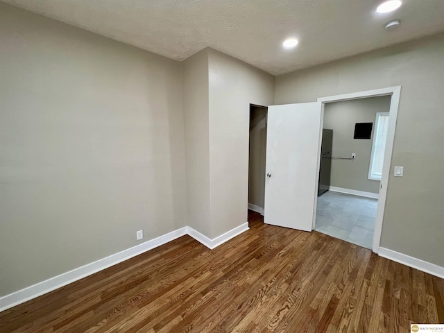 unfurnished room with wood-type flooring