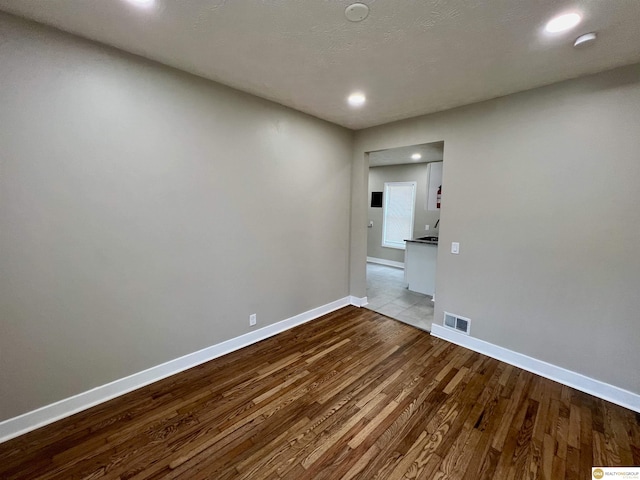 empty room featuring light hardwood / wood-style flooring and a textured ceiling