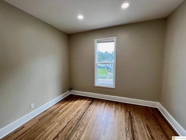 unfurnished room featuring hardwood / wood-style floors