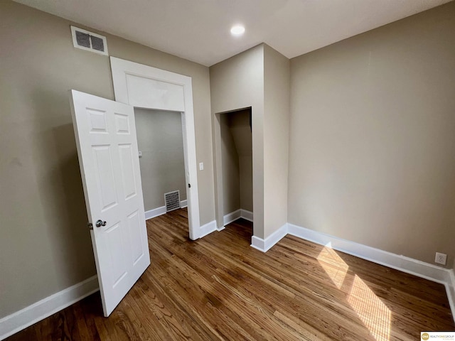 unfurnished bedroom with dark hardwood / wood-style flooring