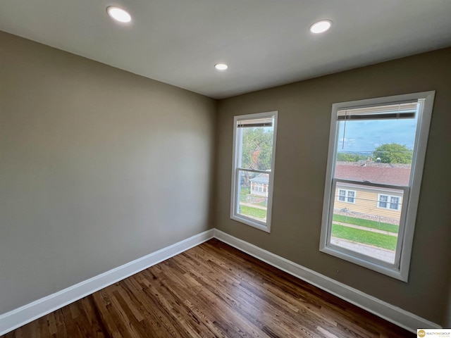 unfurnished room with hardwood / wood-style flooring