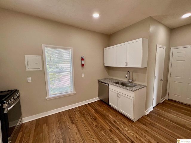 kitchen with white cabinets, stainless steel appliances, sink, and dark wood-type flooring