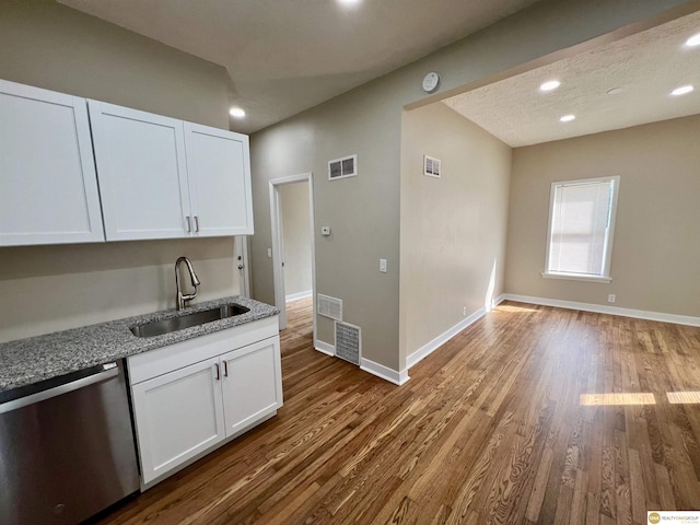 kitchen featuring hardwood / wood-style flooring, dishwasher, light stone counters, sink, and white cabinetry