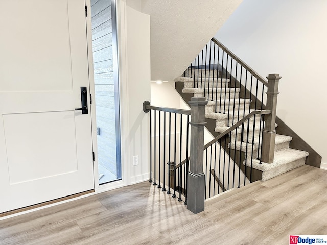 stairs featuring baseboards and wood finished floors