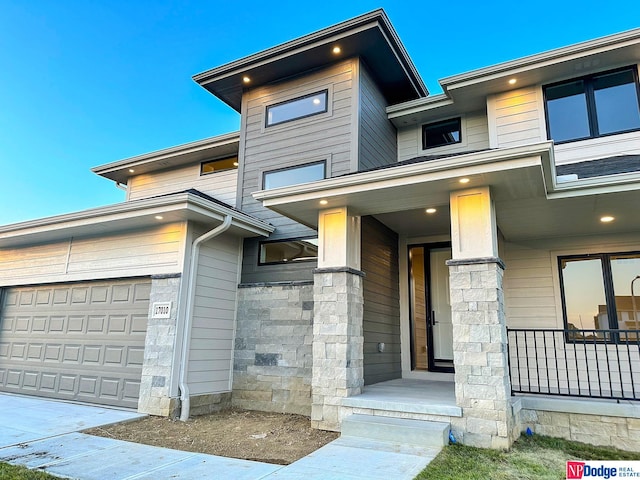 view of front of house featuring stone siding and an attached garage