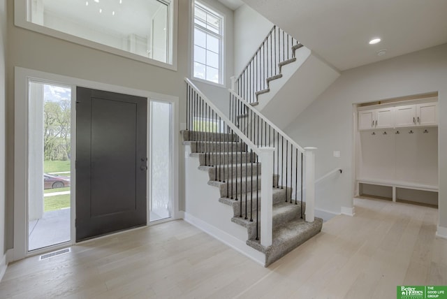 foyer entrance with light hardwood / wood-style floors