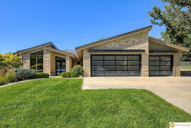 view of front of property with a front lawn and a garage