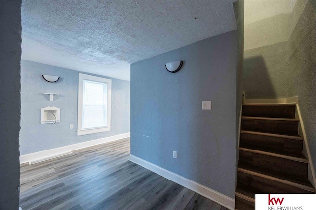 interior space with hardwood / wood-style floors and a textured ceiling