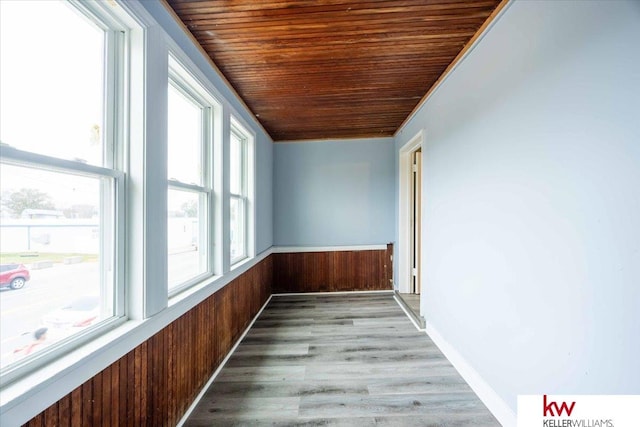 unfurnished sunroom with wood ceiling