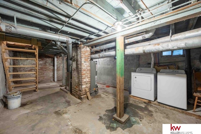 basement with water heater, heating unit, and independent washer and dryer