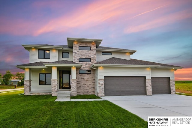 prairie-style home with a lawn and a garage