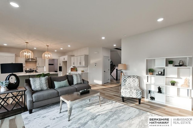 living room with a chandelier and light hardwood / wood-style floors