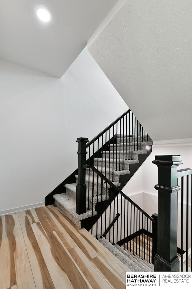 staircase with hardwood / wood-style flooring