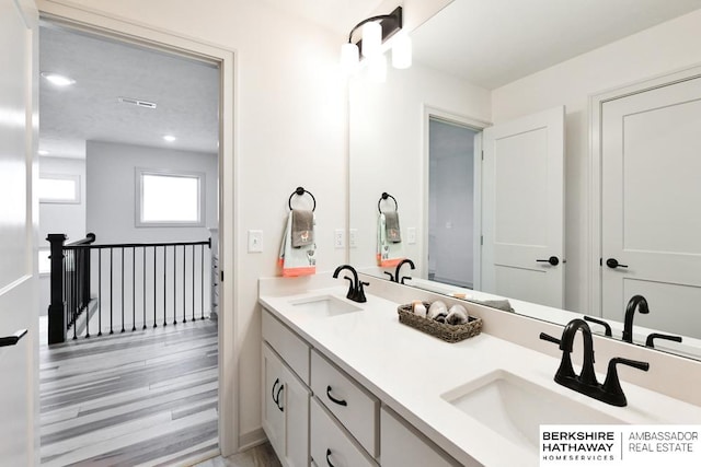 bathroom featuring hardwood / wood-style flooring and vanity