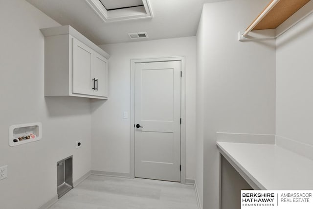 washroom featuring hookup for a washing machine, light hardwood / wood-style flooring, cabinets, and electric dryer hookup