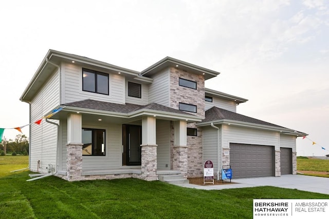 prairie-style home featuring a garage and a front yard