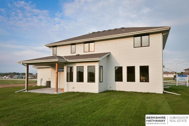 rear view of property with a lawn and a patio area