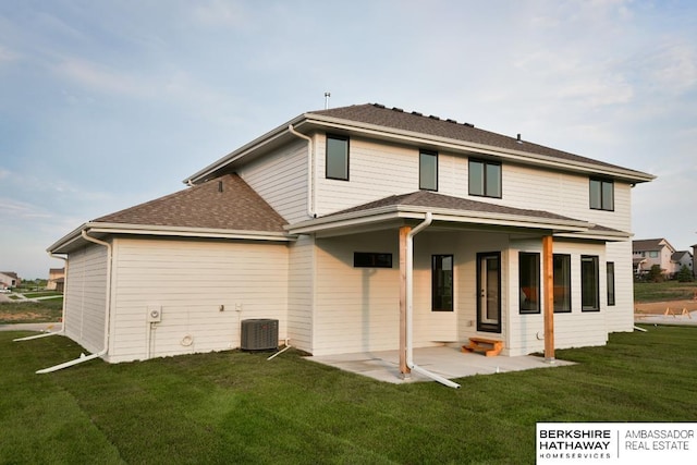 back of property with a lawn and a patio area