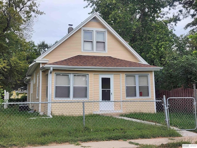 bungalow-style house with a front yard