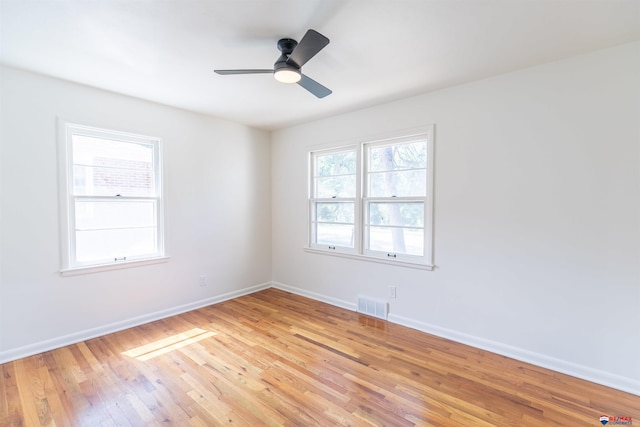 empty room featuring light wood-type flooring and ceiling fan