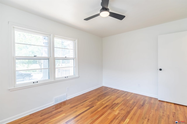 spare room featuring hardwood / wood-style floors and ceiling fan