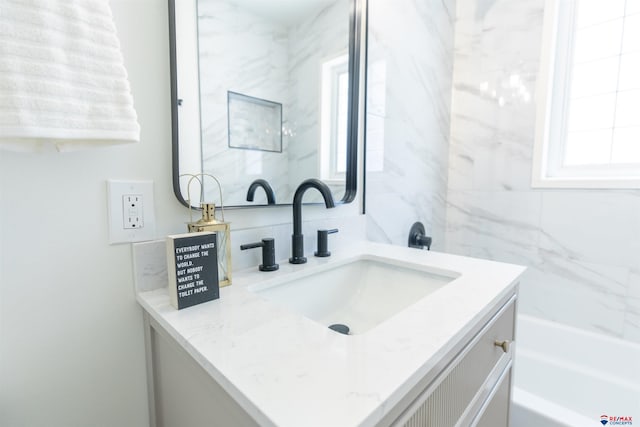 bathroom with vanity and shower with separate bathtub