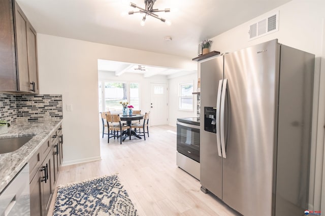 kitchen featuring beamed ceiling, light hardwood / wood-style flooring, backsplash, light stone countertops, and appliances with stainless steel finishes