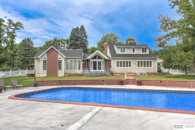 rear view of property featuring a yard