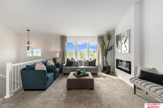 carpeted living room with a wealth of natural light and an inviting chandelier