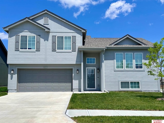 view of front of property with a garage and a front lawn