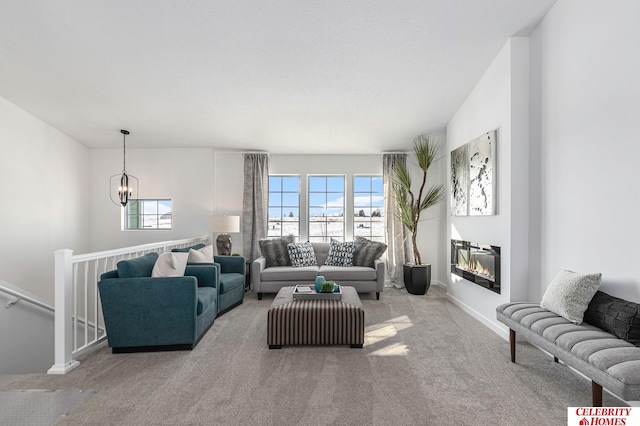 carpeted living room with a notable chandelier