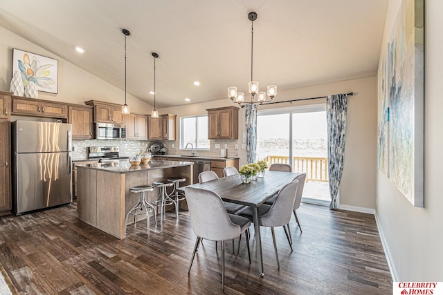 dining room with high vaulted ceiling, a chandelier, dark hardwood / wood-style flooring, and sink