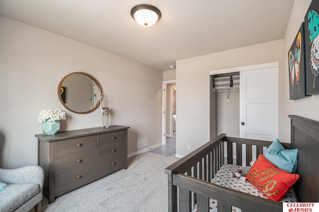 carpeted bedroom with a closet and a crib