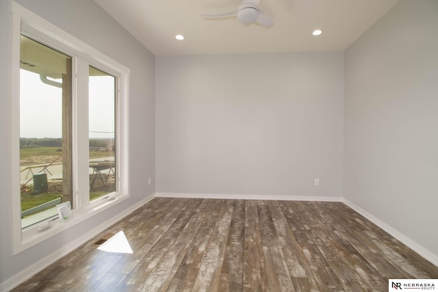 spare room featuring ceiling fan and dark hardwood / wood-style flooring