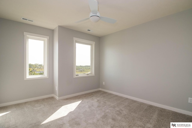 unfurnished room with ceiling fan and light colored carpet