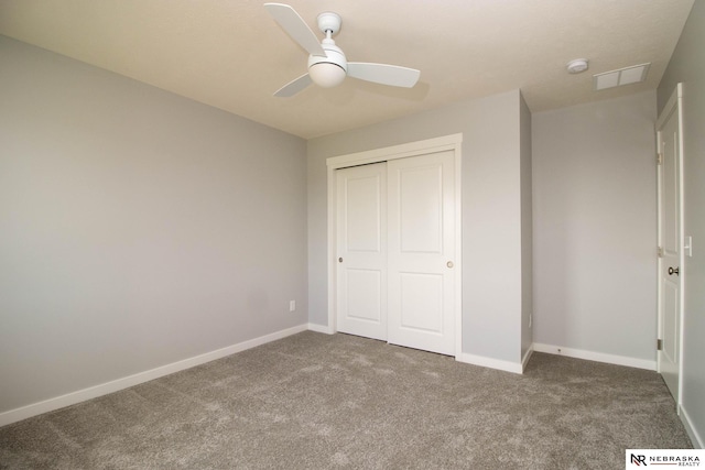 unfurnished bedroom with ceiling fan, a closet, and carpet