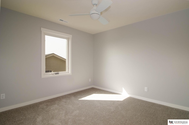 carpeted spare room featuring ceiling fan