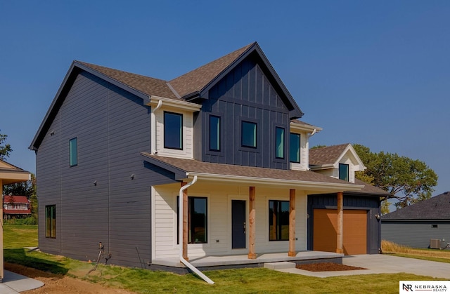 exterior space with central AC, a front yard, and a garage