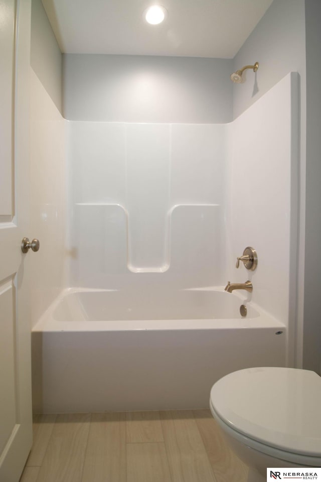 bathroom featuring toilet and bathtub / shower combination