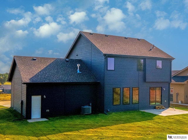 rear view of property featuring a yard, central air condition unit, and a patio area