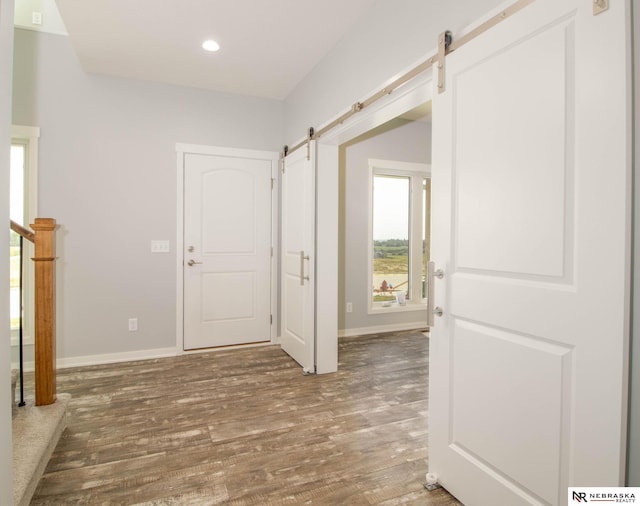 entrance foyer featuring a barn door and hardwood / wood-style floors