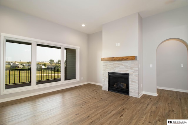 unfurnished living room featuring a fireplace and hardwood / wood-style flooring