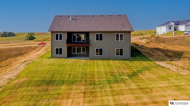 back of property featuring a lawn and a patio