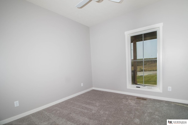 carpeted spare room featuring ceiling fan