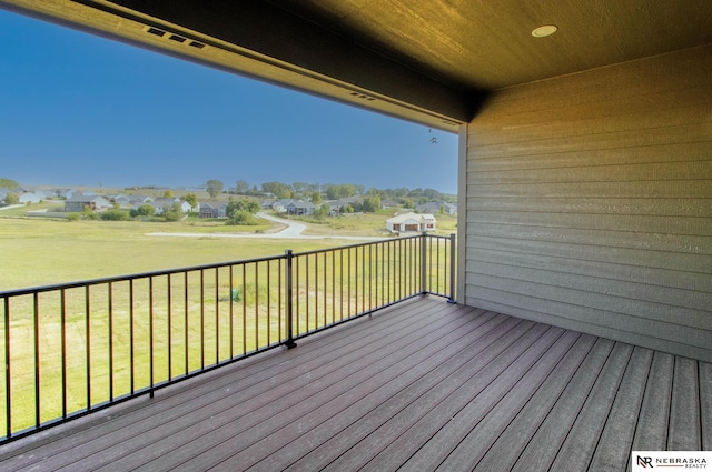 wooden terrace with a lawn