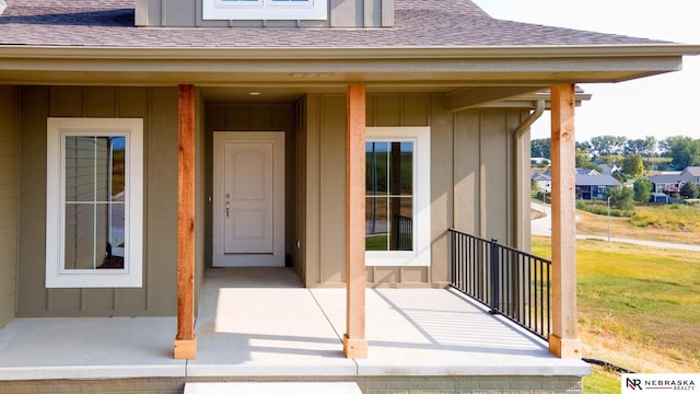 view of exterior entry featuring a porch