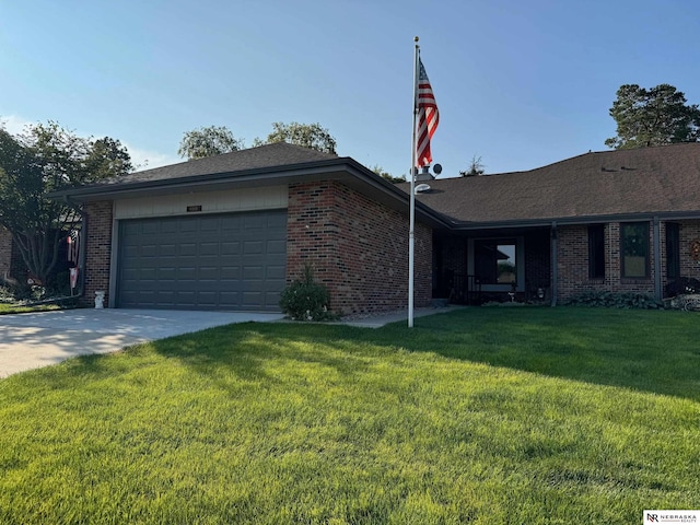 ranch-style house featuring a front lawn and a garage