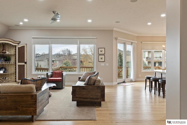 living room featuring light wood-type flooring and ornamental molding