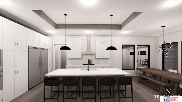 kitchen with wall chimney exhaust hood, pendant lighting, and dark wood-type flooring